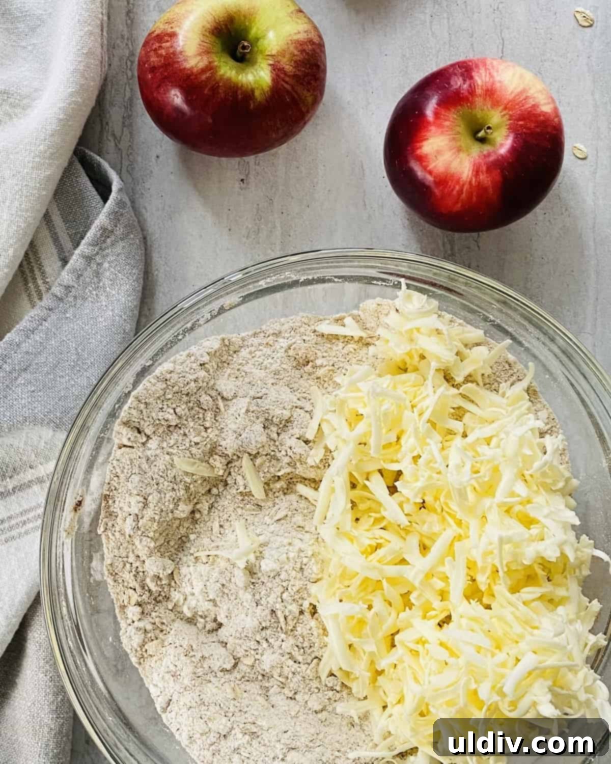 Spiced Apple Crumb Bars 5 Flour and sugar with shredded butter in a bowl.
