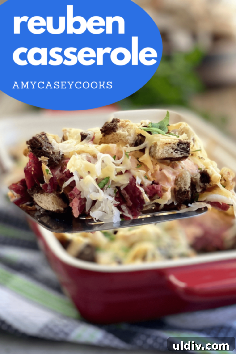 Easy and Delicious Reuben Casserole Recipe 11 A close-up of a layered casserole featuring corned beef, rye bread cubes, sauerkraut, and a creamy dressing, topped with melted cheese.