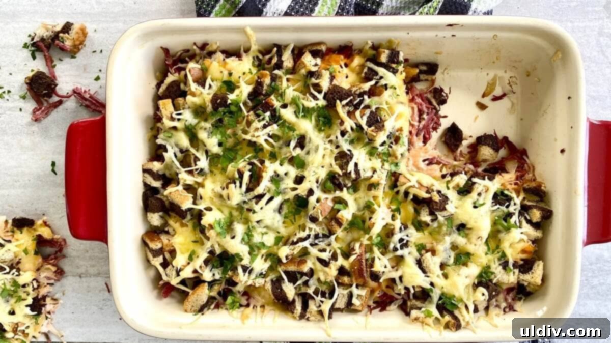 Easy and Delicious Reuben Casserole Recipe 3 A whole corned beef casserole with a single serving portion carefully cut out and ready to be served.