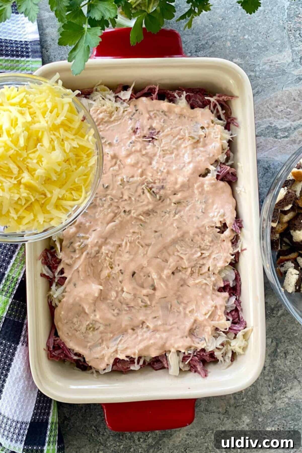 Easy and Delicious Reuben Casserole Recipe 7 Sprinkling shredded Swiss cheese over the dressing layer in the casserole.