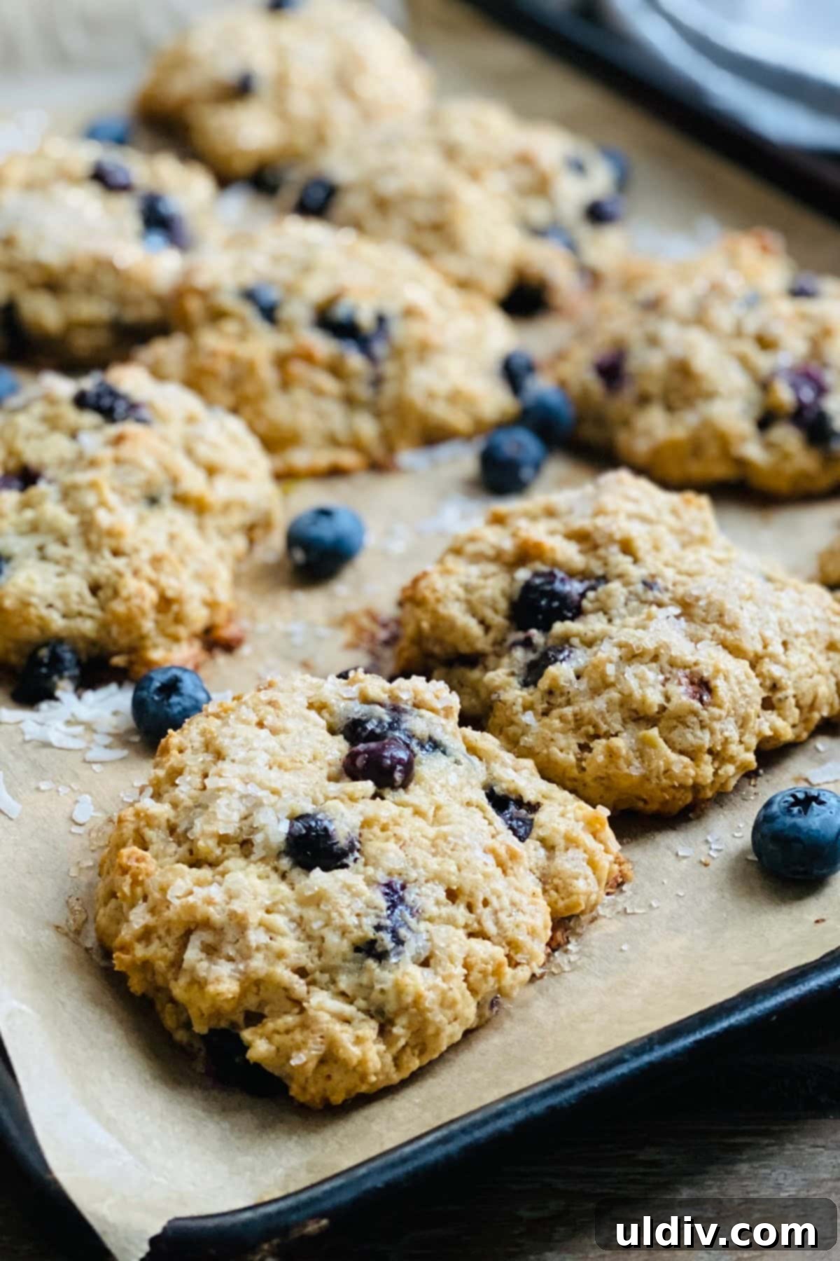 No-Fuss Blueberry Drop Scones 6 Baked buttery biscuit like treat on parchment.