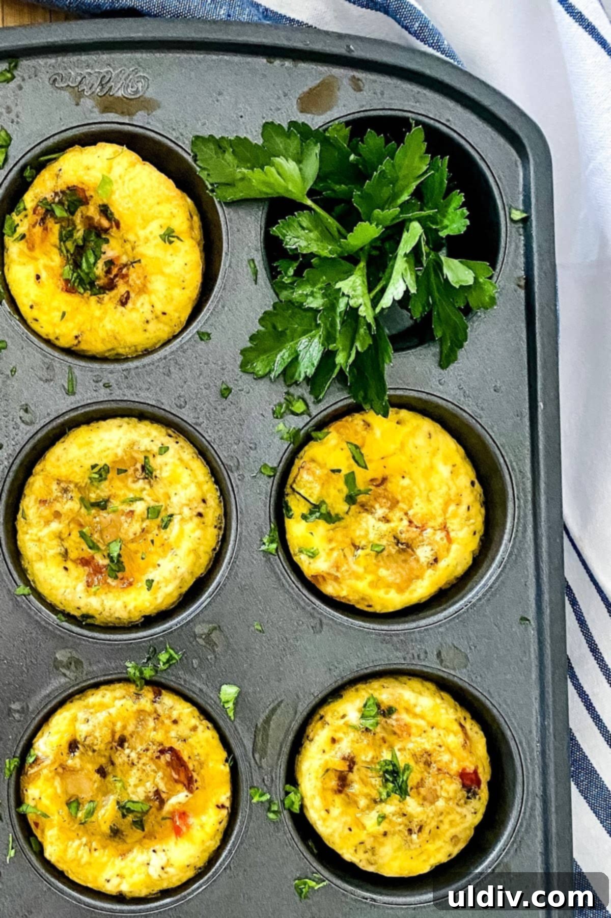 Keto and Paleo Egg Muffins 2 A muffin tin filled with freshly baked scrambled egg cups, ready for serving.