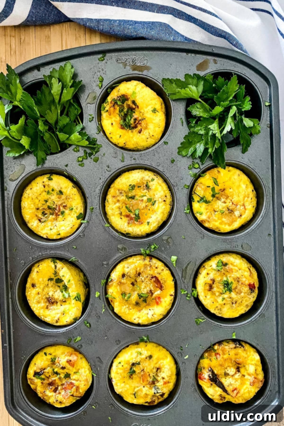Keto and Paleo Egg Muffins 5 A muffin tin filled with freshly baked scrambled eggs, viewed from above.