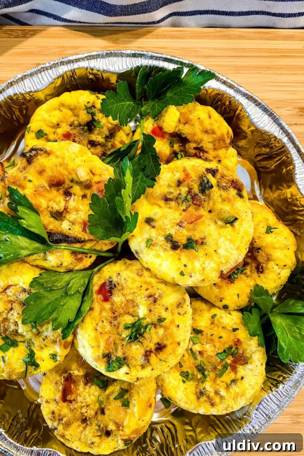 Keto and Paleo Egg Muffins 6 A collection of various meal prep containers, ready for the refrigerator, showing organized breakfast options.
