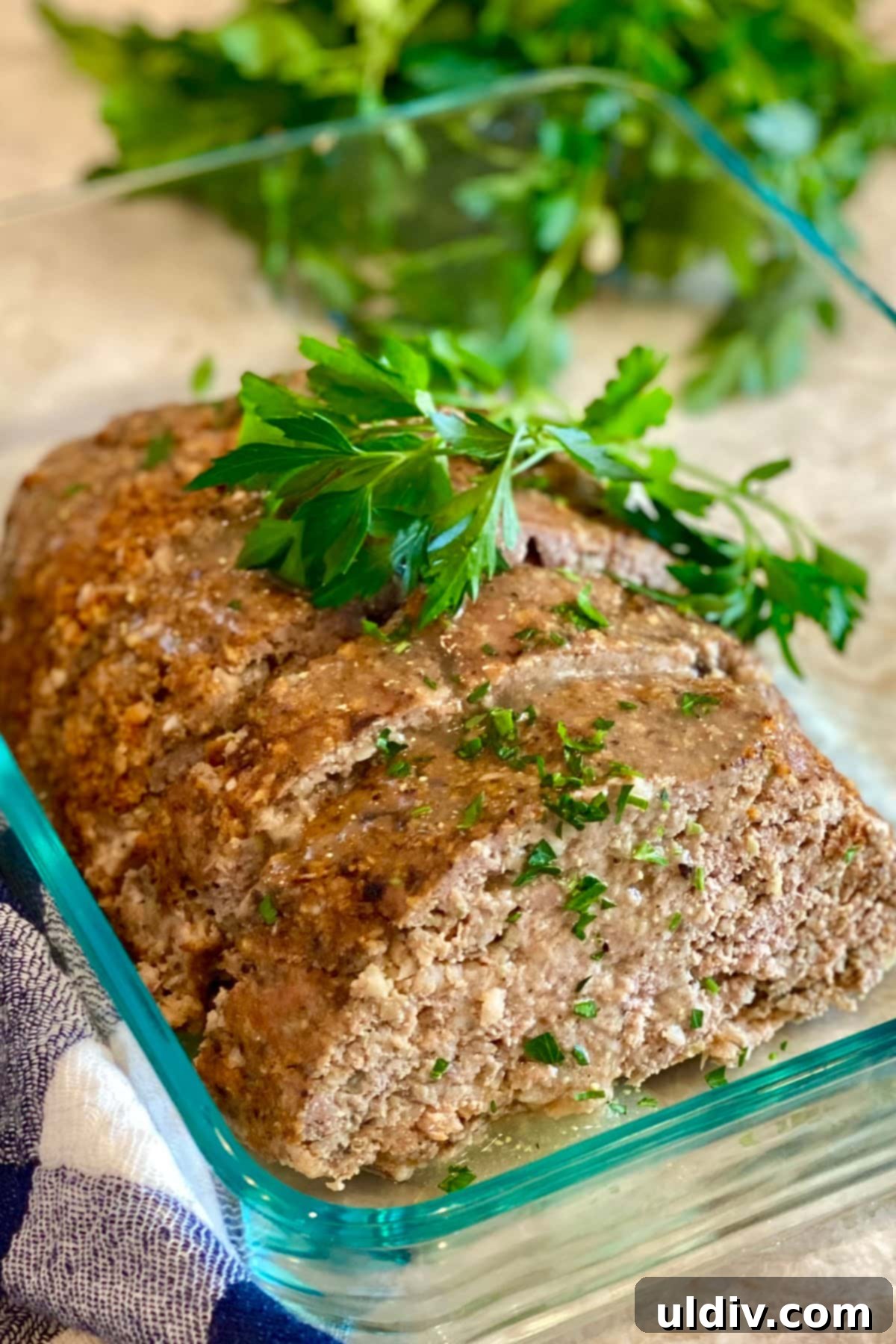 Comforting Turkey Meatloaf with Savory Mushrooms 2 A turkey meatloaf with mushrooms sliced and stored in a glass container, ready for serving or meal prep.