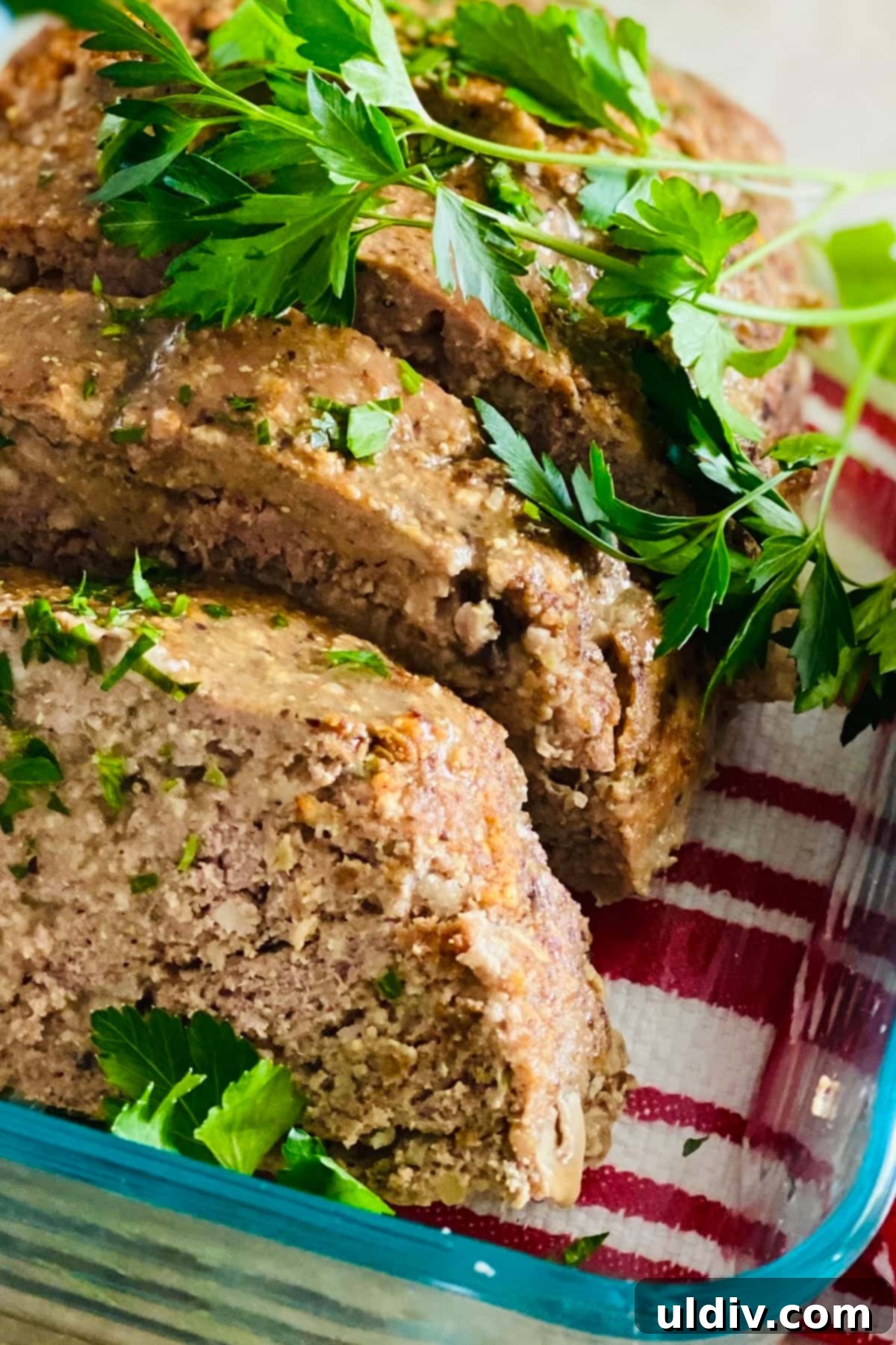 Comforting Turkey Meatloaf with Savory Mushrooms 3 A perfectly sliced turkey meatloaf with mushrooms, garnished with fresh parsley, ready to be served.