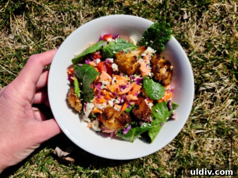 Close-up of the vibrant salmon, kale, and cauliflower salad in a bowl