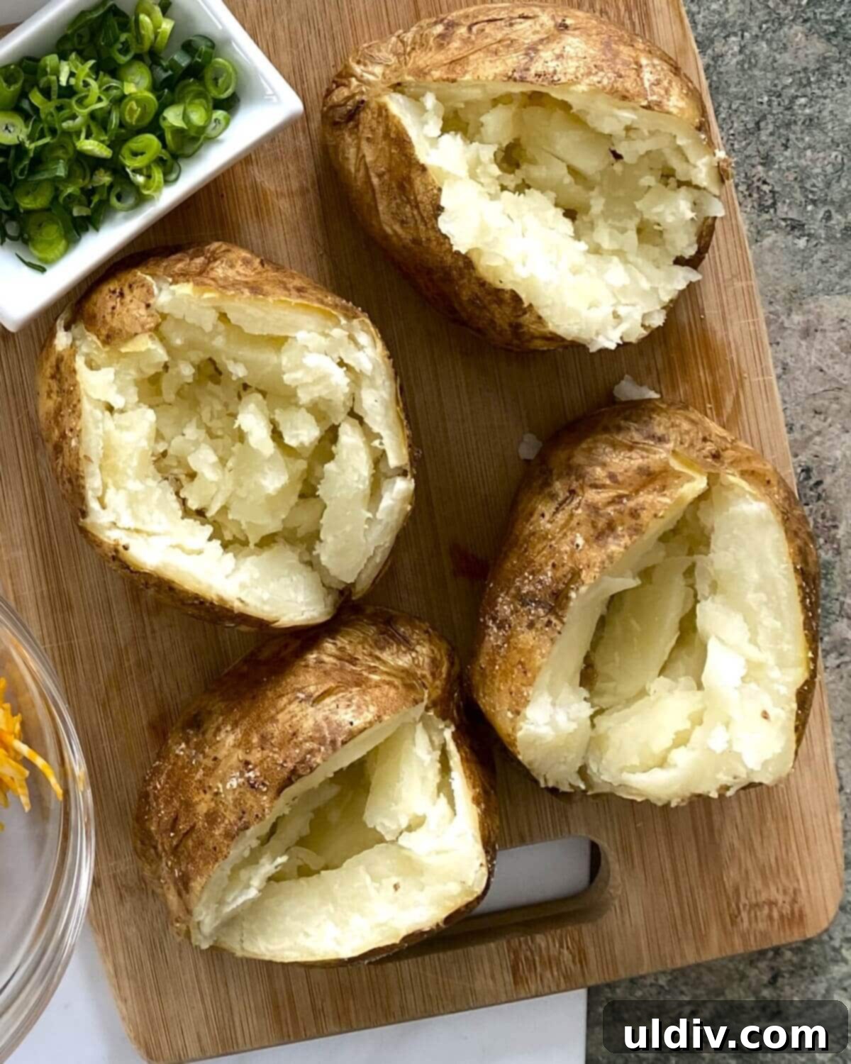 Loaded Turkey Sloppy Joe Potatoes 4 baked potatoes that are cut open.