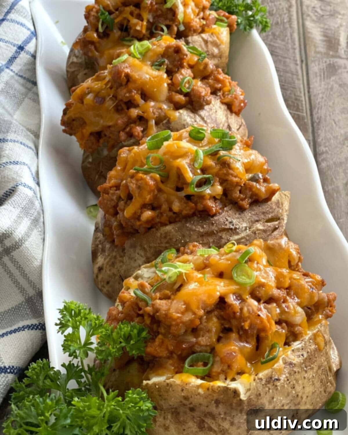 Turkey Sloppy Joe Potato Bake 9 Four generously stuffed Turkey Sloppy Joe Baked Potatoes, perfectly arranged and ready to be served as a wholesome and hearty meal.