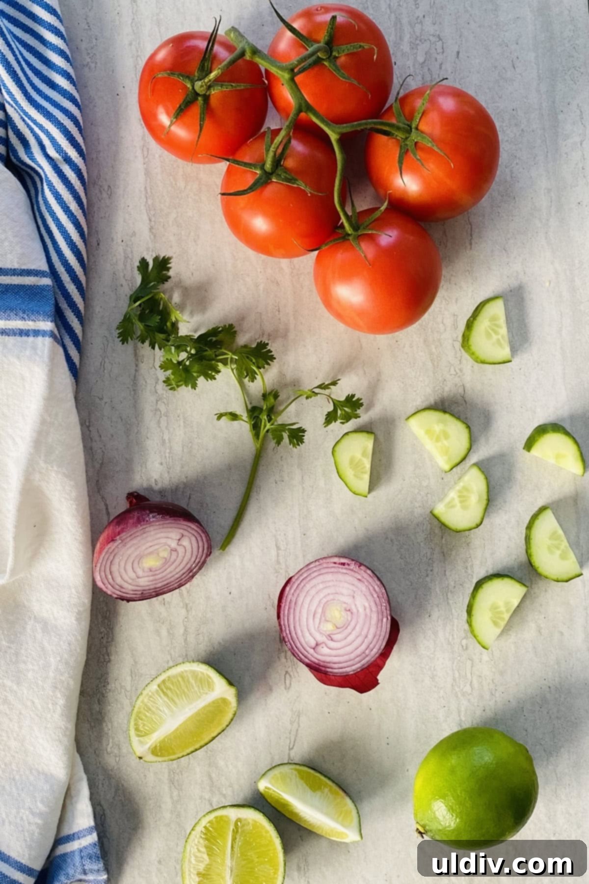Bright & Zesty Pico 3 The vibrant ingredients for a fresh Pico de Gallo recipe, including ripe tomatoes, bright lime, crisp red onion, fragrant cilantro, and cool cucumber, arranged on a rustic surface.