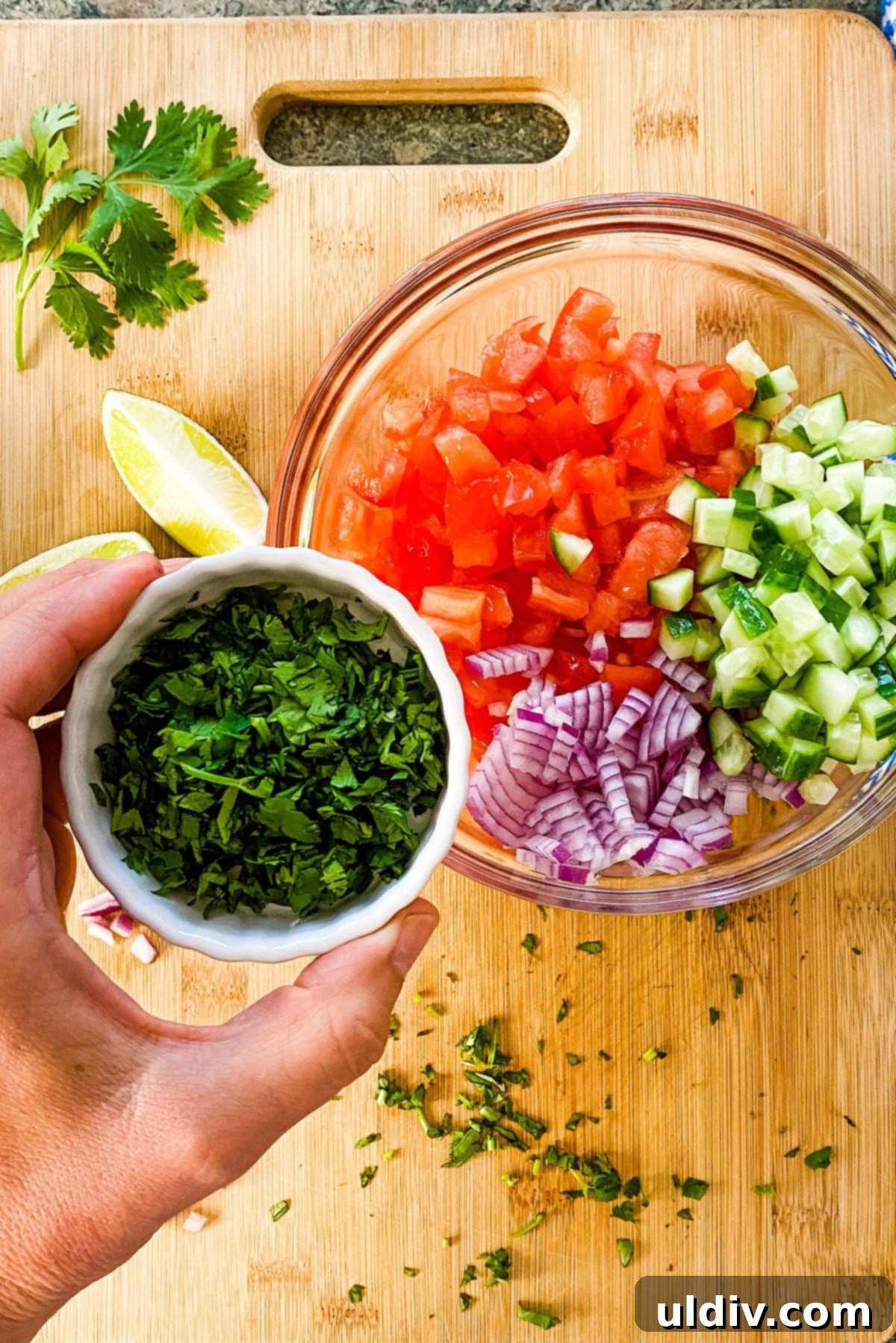 Bright & Zesty Pico 4 Freshly chopped cilantro being added to a bowl of vibrant, diced salsa ingredients.