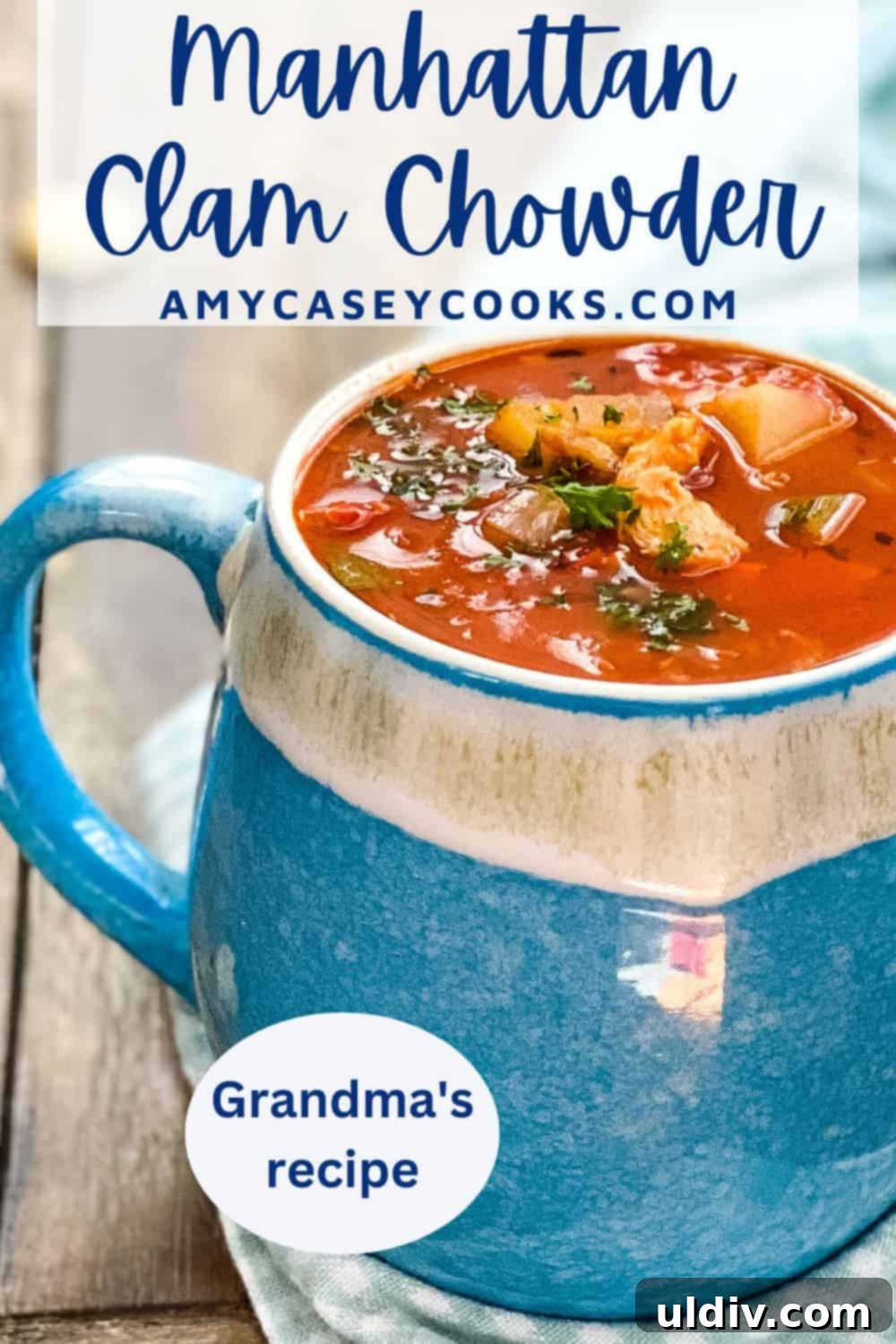 Grandma's Classic Manhattan Clam Chowder Recipe 10 A close-up of a rustic mug filled with steaming Manhattan clam chowder, invitingly presented on a wooden surface.