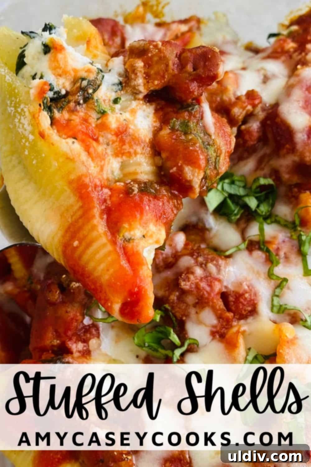 Italian Sausage Stuffed Shells 9 A close-up shot of a single baked stuffed pasta shell with a generous amount of melted cheese and a hint of spinach, ready to be enjoyed.