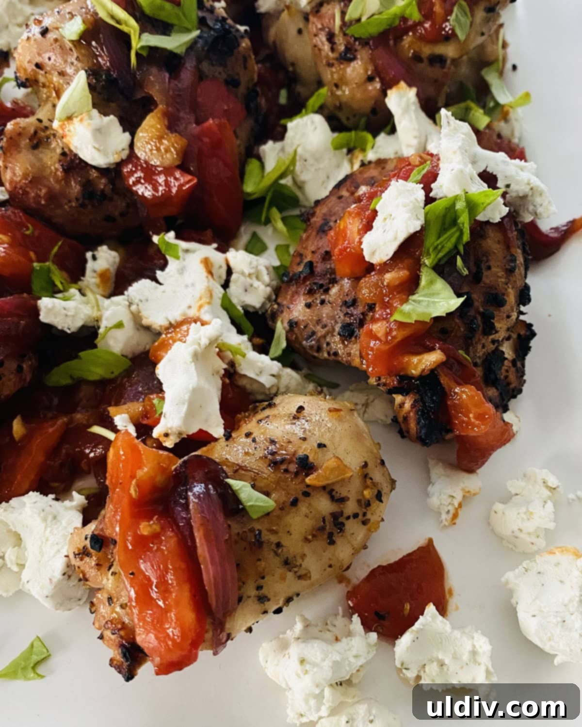 Bruschetta & Goat Cheese Grilled Chicken 2 Grilled chicken thighs topped with sautéed bruschetta and crumbled goat cheese on a serving platter
