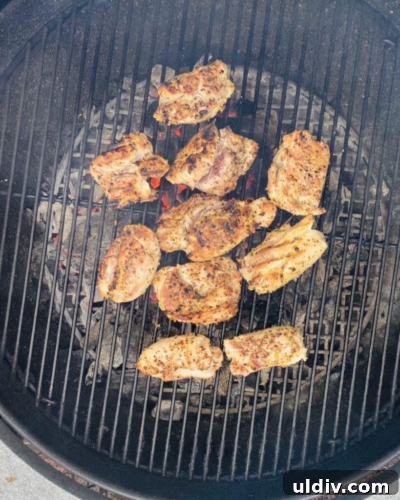 Tuscan Grilled Chicken with Goat Cheese and Sautéed Tomato Basil 4 chicken thighs grilling on a Weber grill