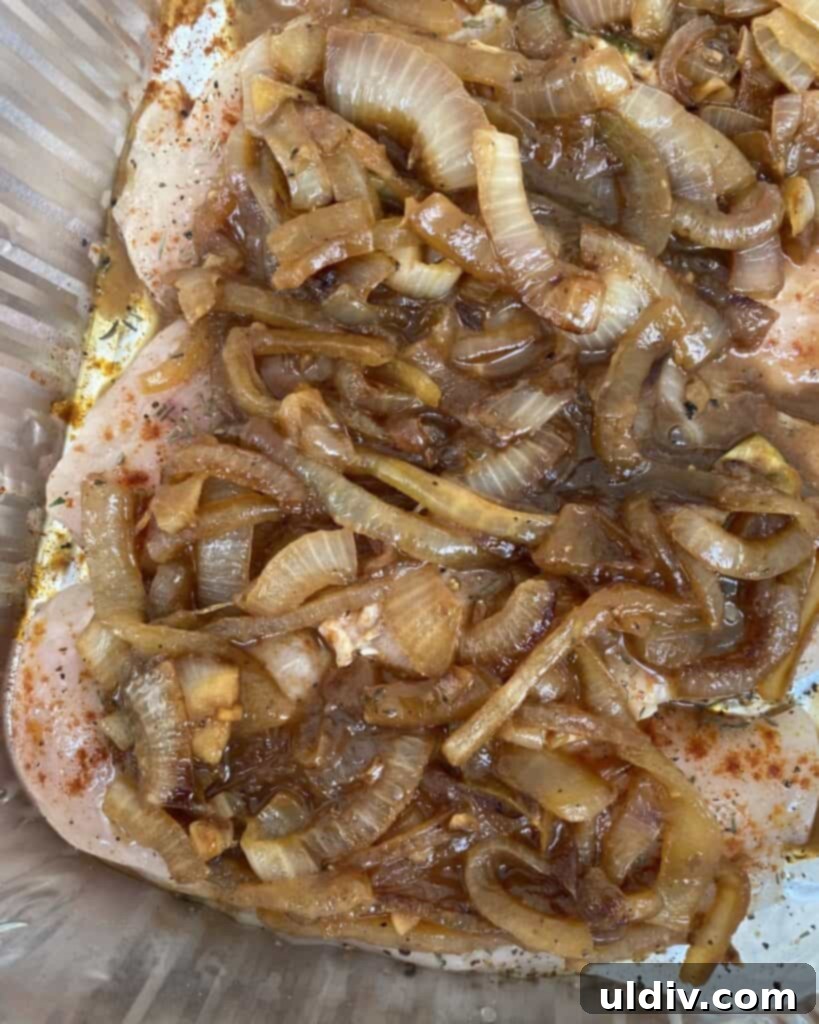Classic French Onion Chicken Bake 5 Thin chicken cutlets arranged in a baking dish, topped with a generous layer of caramelized onions.