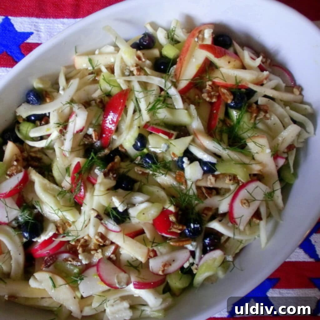 Crisp Apple, Fennel, and Radish Slaw with Blue Cheese and Pecans 6 Close-up of a fresh apple fennel slaw with pecans and blue cheese, showing vibrant colors and textures.