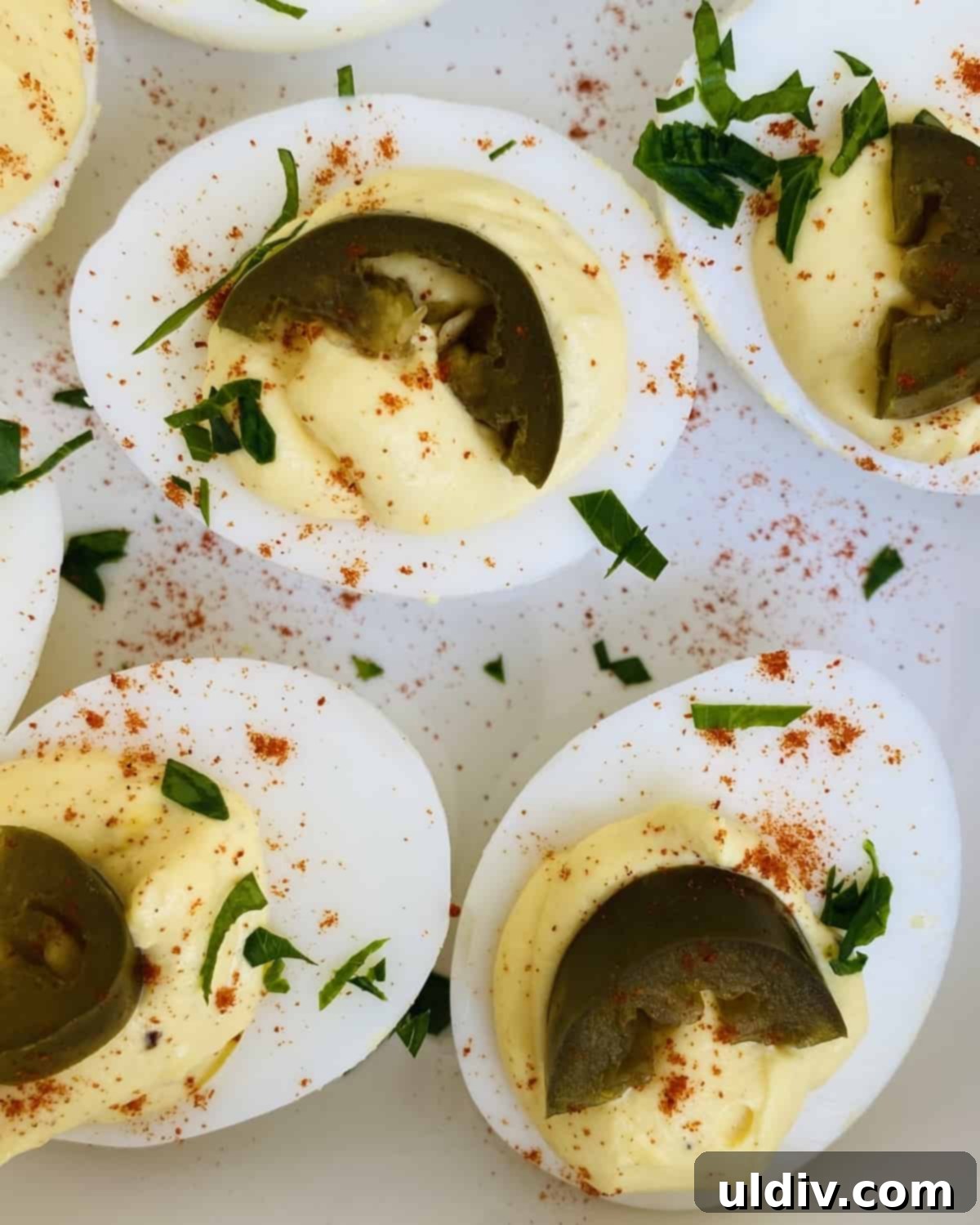 Jalapeno Kick Deviled Eggs 6 Close-up of deviled eggs adorned with bright green pickled jalapeno slices