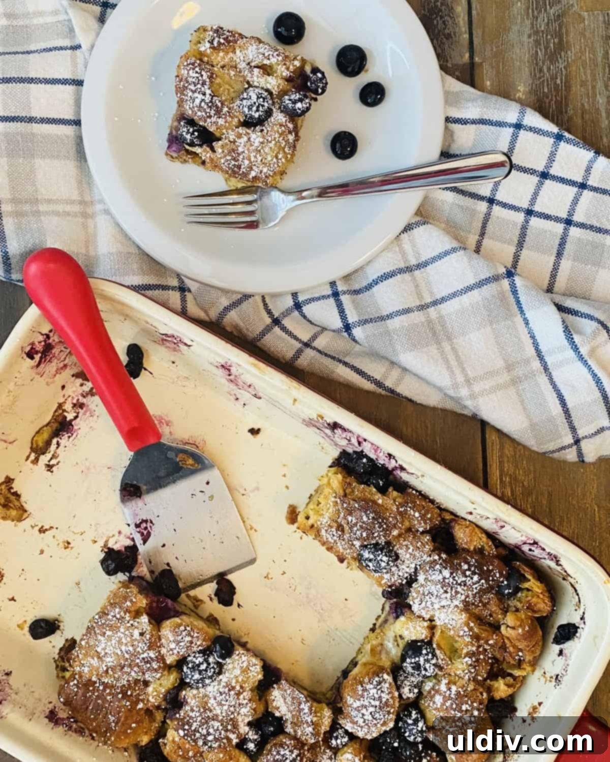 Blueberry Croissant French Toast Bake 6 breakfast with a few pieces cut out and served with maple syrup
