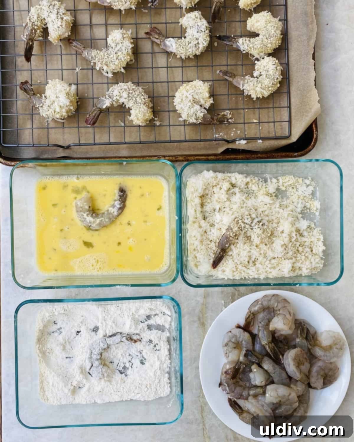 Crunchy Golden Coconut Shrimp Perfection 4 Dredging station with bowls of flour and beaten eggs for coating shrimp