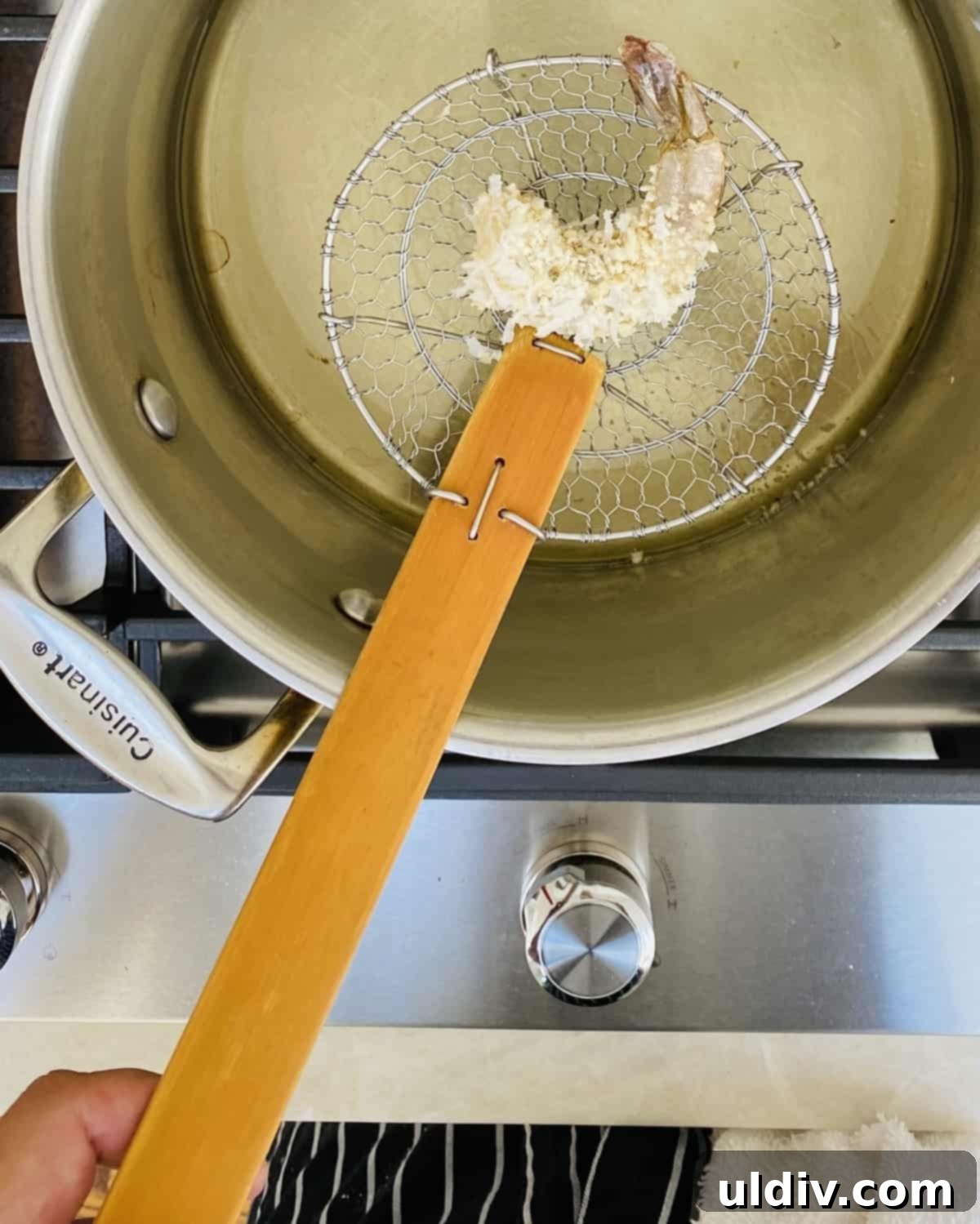 Crunchy Golden Coconut Shrimp Perfection 6 Coconut shrimp frying in hot oil in a stock pot