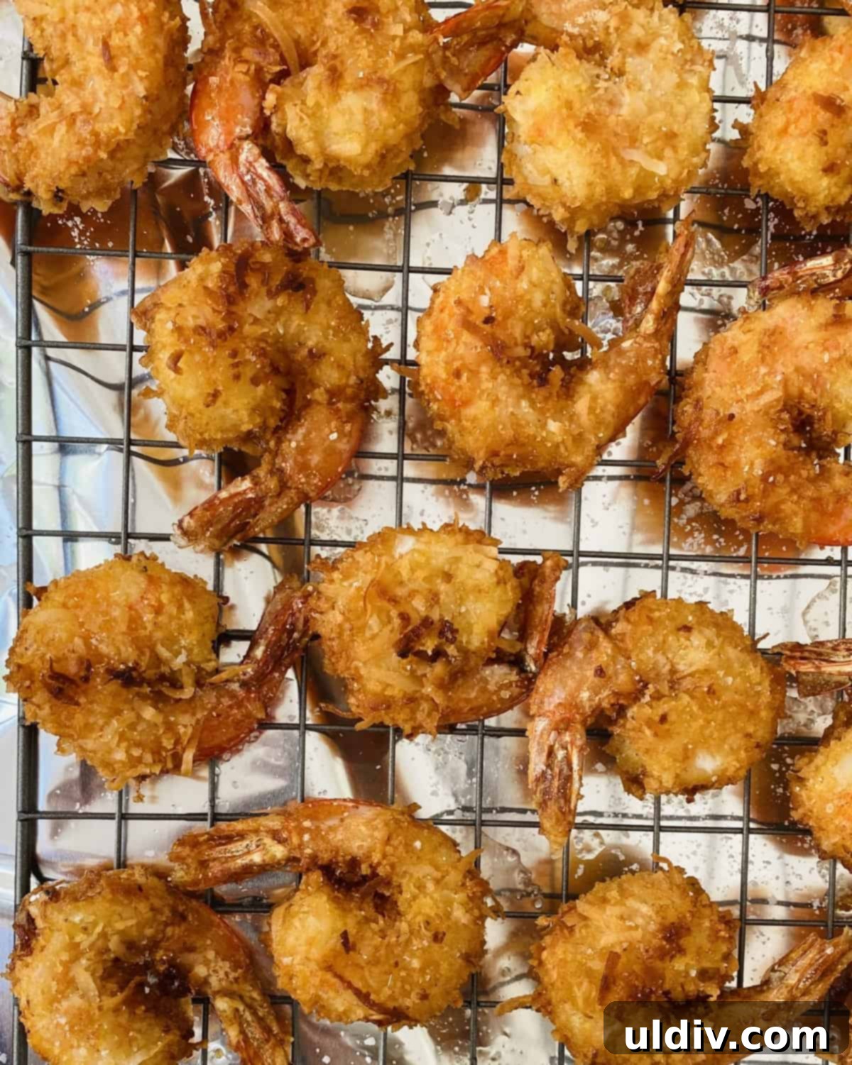 Tropical Coconut Crunch Shrimp 7 Freshly fried coconut shrimp draining on a cooling rack
