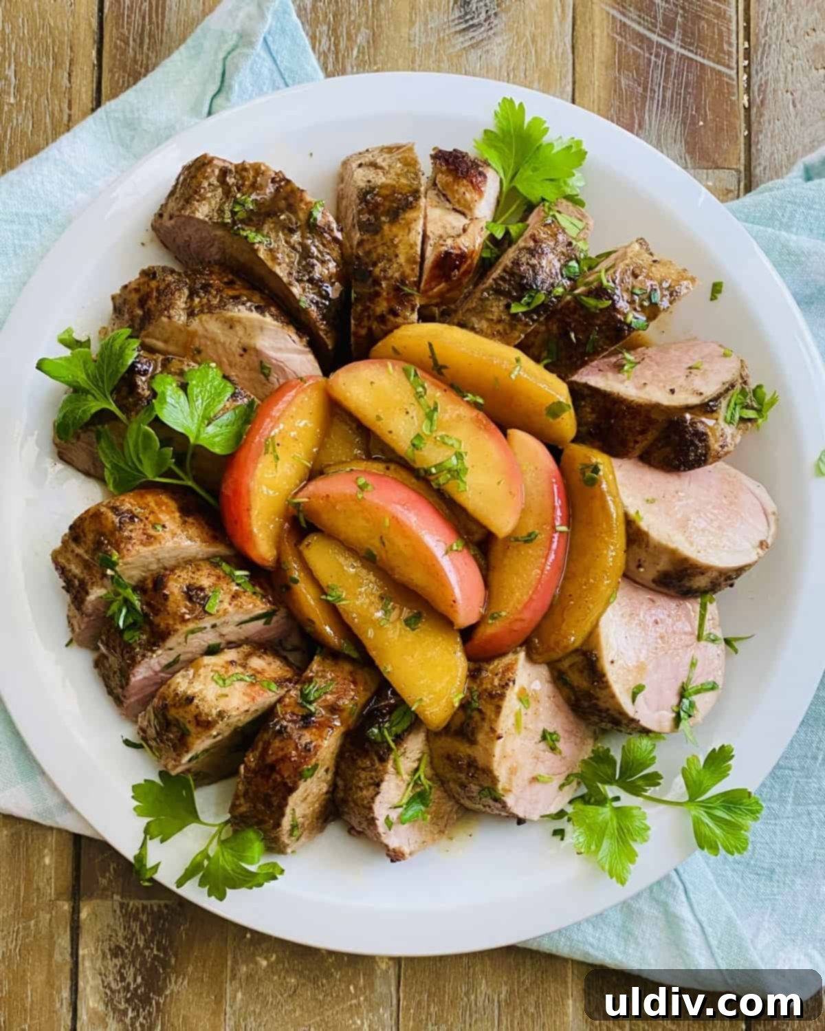 Maple Glazed Pork Tenderloin with Caramelized Apples 8 A platter of roasted pork with apples.