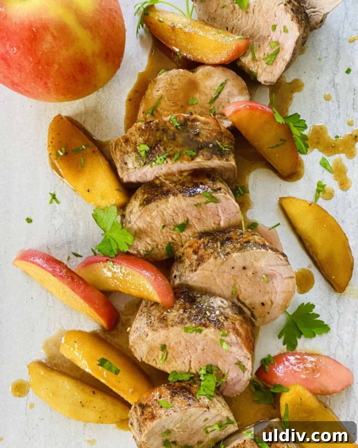 Maple Glazed Tenderloin with Caramelized Apples 9 A sliced pork tenderloin drizzled with maple glaze and with sautéed apples.