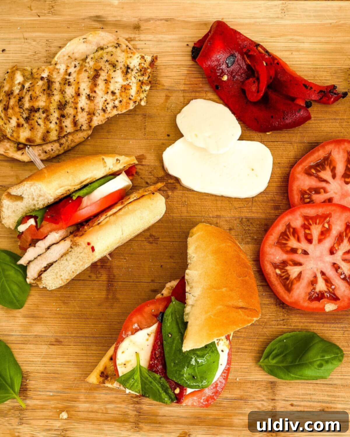 Vibrant Caprese Chicken Sandwich 8 Grilled chicken, mozzarella, sliced tomato on a cutting board.