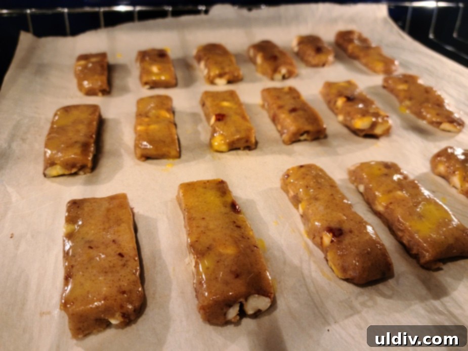 Totenbeinli: Switzerland's Exquisite Seasonal Treat 3 Freshly baked Totenbeinli cookies, golden brown and perfectly crisp, cooling on a wire rack.