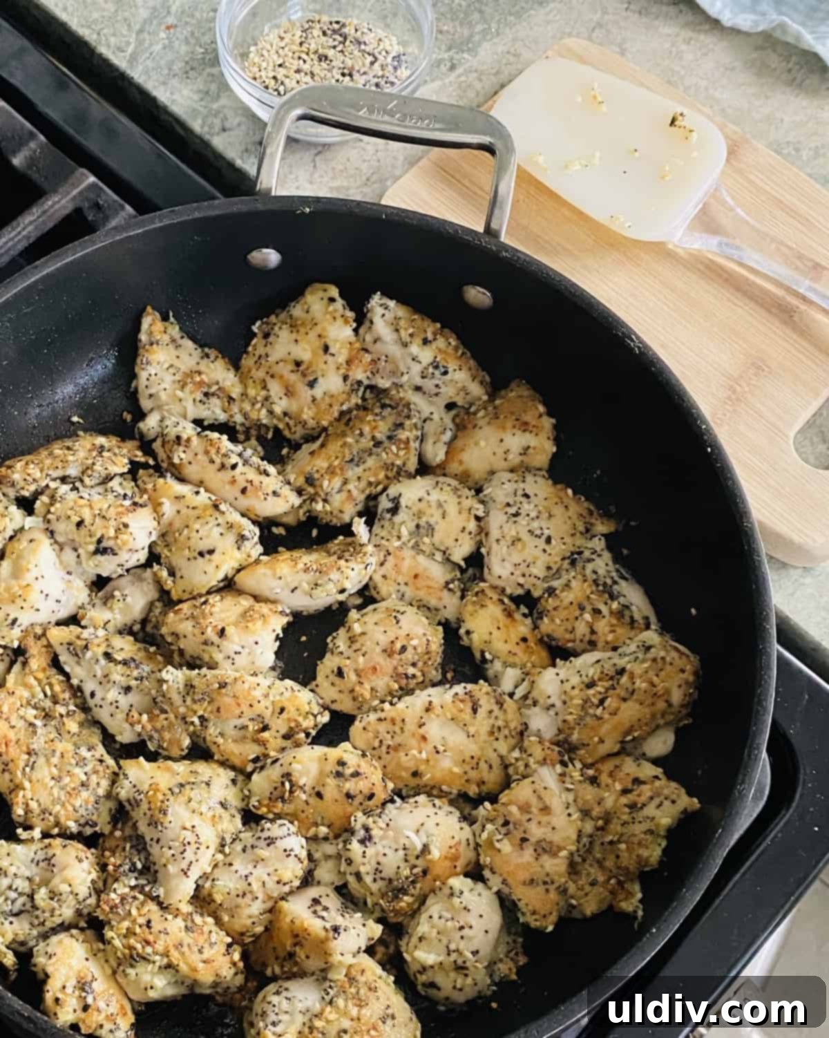Ultimate Everything Chicken Bites with Fresh Basil Hummus 7 Cooking Everything But The Bagel seasoned chicken in a hot sauté pan, achieving a golden brown sear.