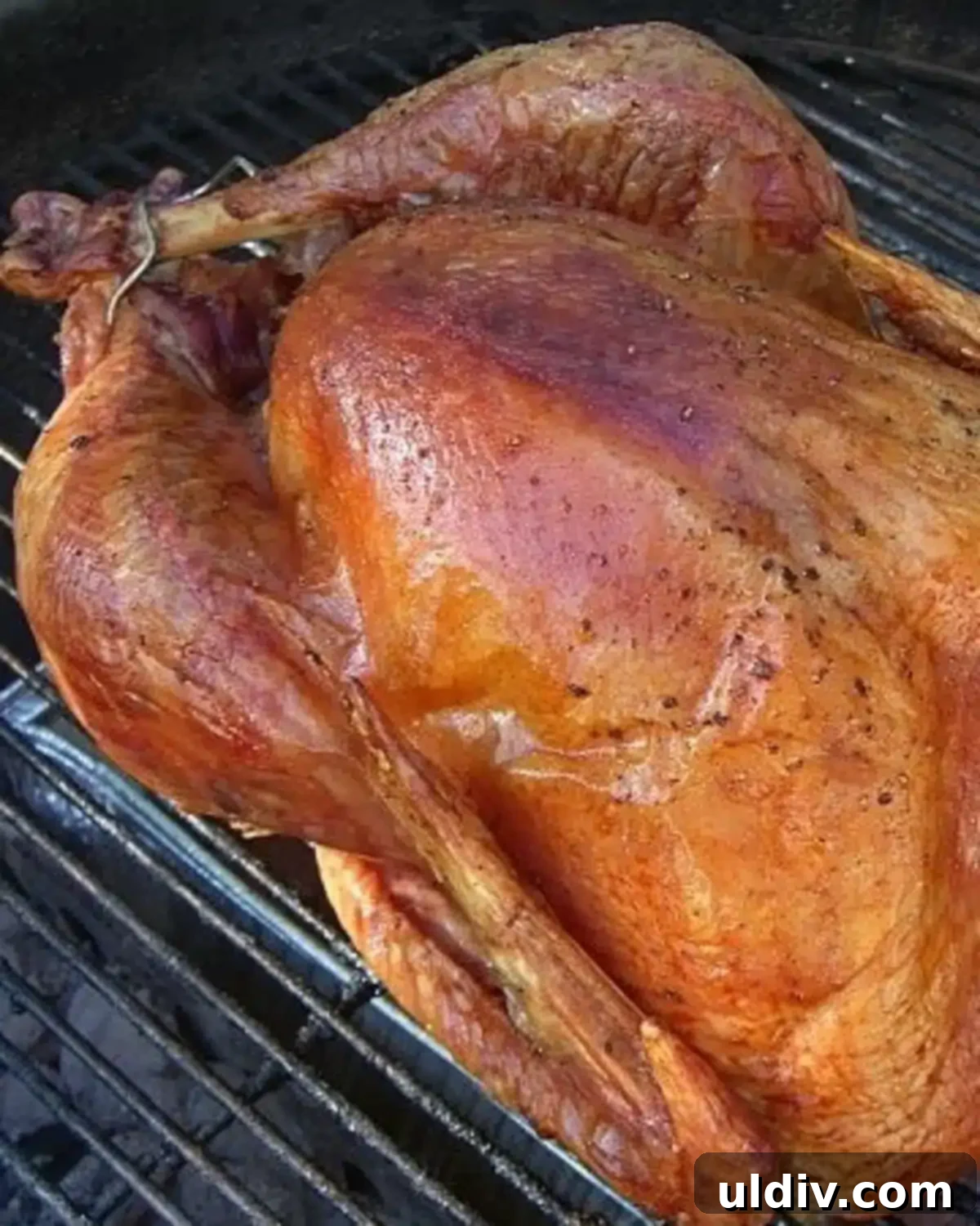 Grill a Whole Turkey Like a Pro 2 a whole grilled turkey on a Weber charcoal grill.