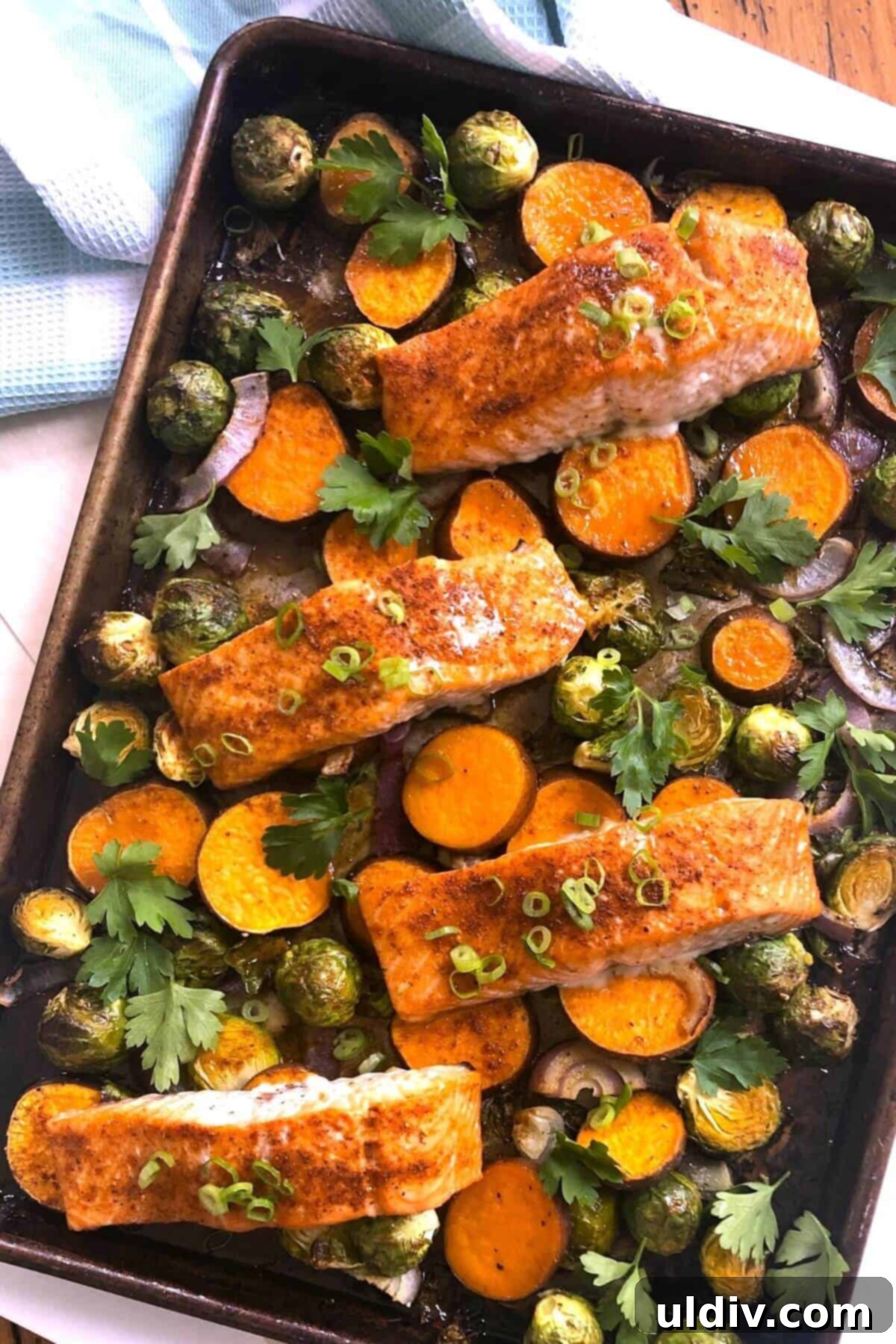 One-Pan Maple Salmon with Roasted Sweet Potatoes and Brussels Sprouts 2 salmon, sweet potatoes, brussels sprouts cooked.