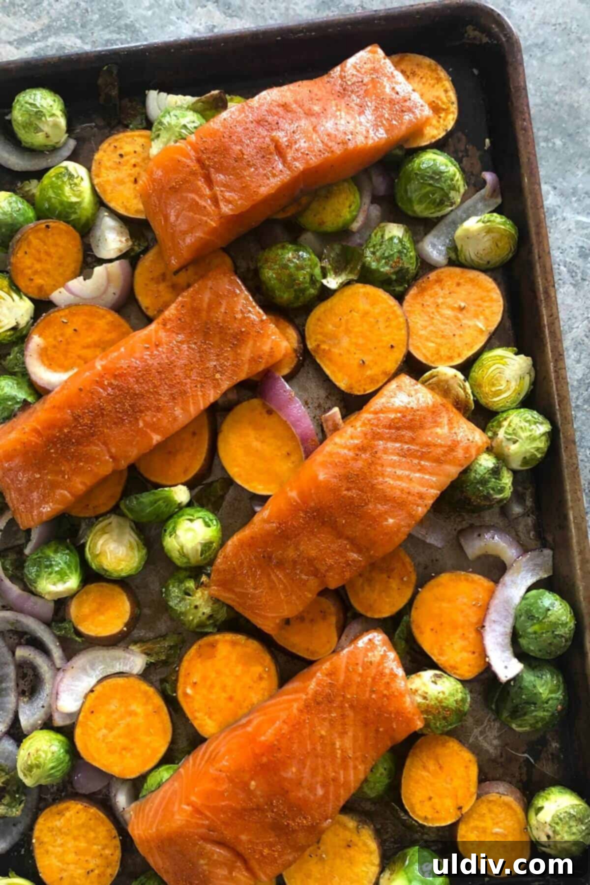 One-Pan Maple Salmon with Sweet Potatoes and Brussels Sprouts 4 uncooked salmon sheet pan dinner.