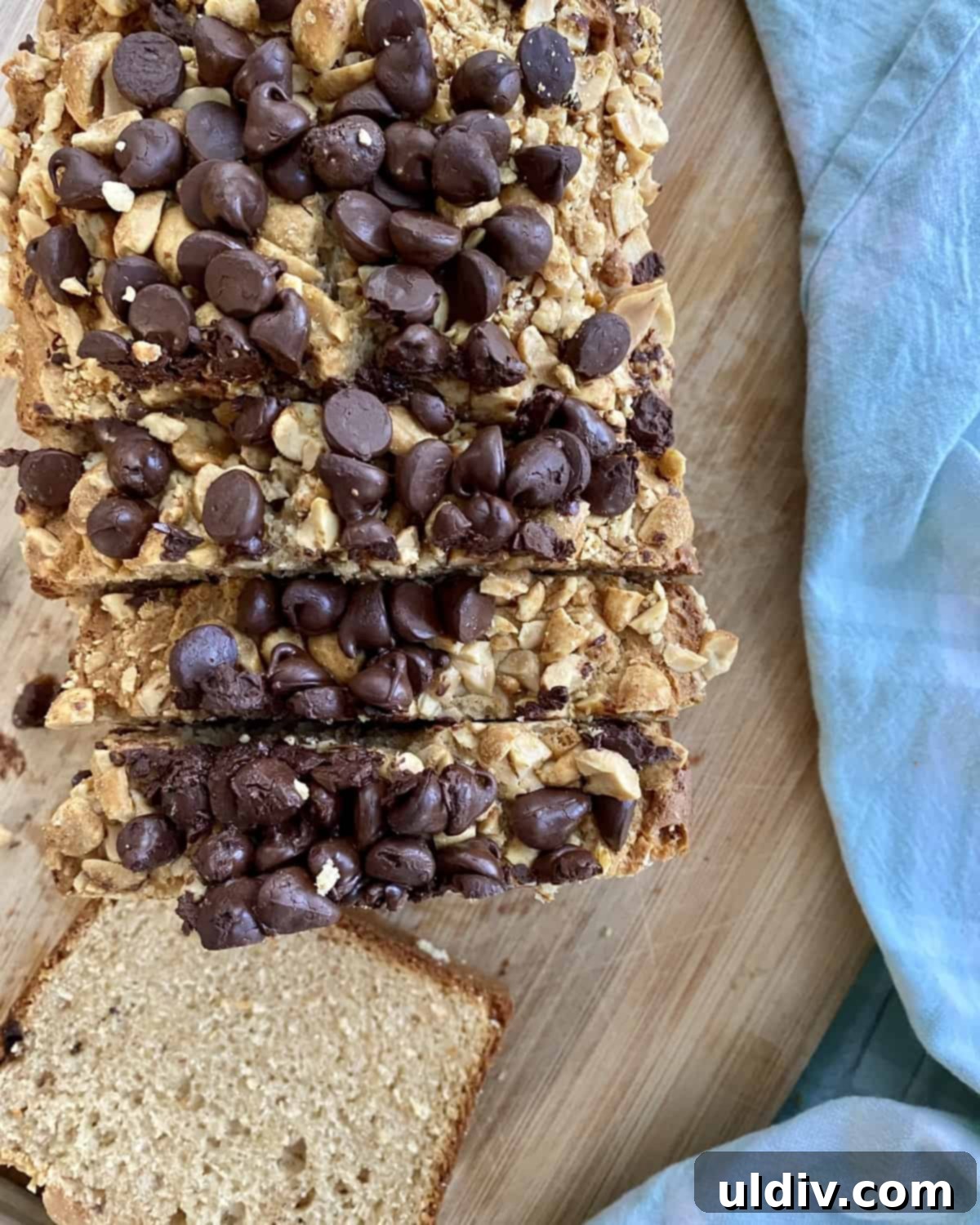 Chocolate Chip Peanut Butter Crunch Bread 8 A perfectly sliced loaf of chocolate chip peanut butter bread, topped with visible peanuts and chocolate chips.