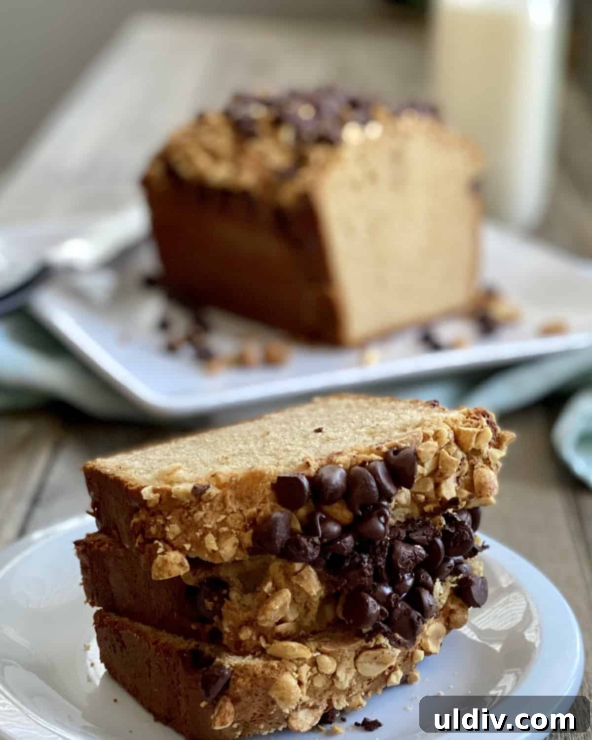 Chocolate Chip Peanut Butter Crunch Bread 9 Three slices of chocolate chip peanut butter bread stacked neatly, showcasing its moist texture and delicious toppings.