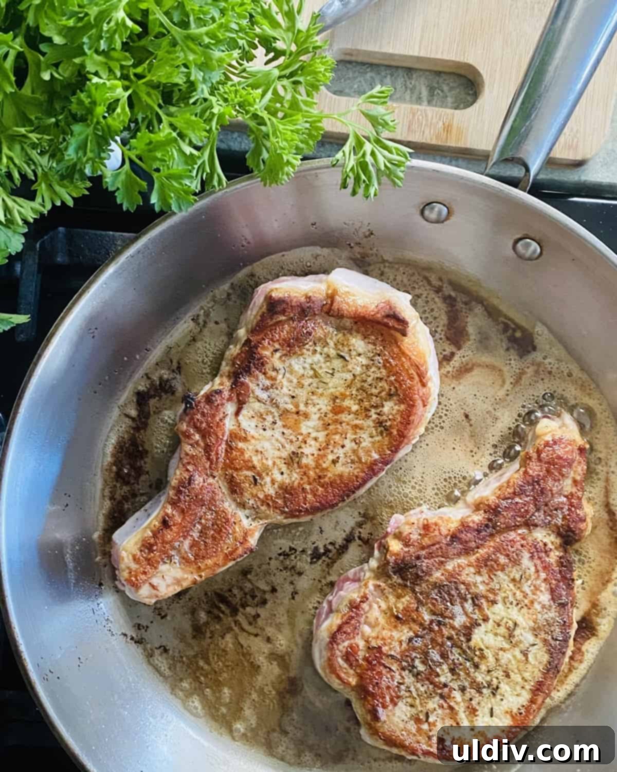 Braised Pork Chops with Savory Mushroom Sauce 7 Searing pork chops in a sauté pan.