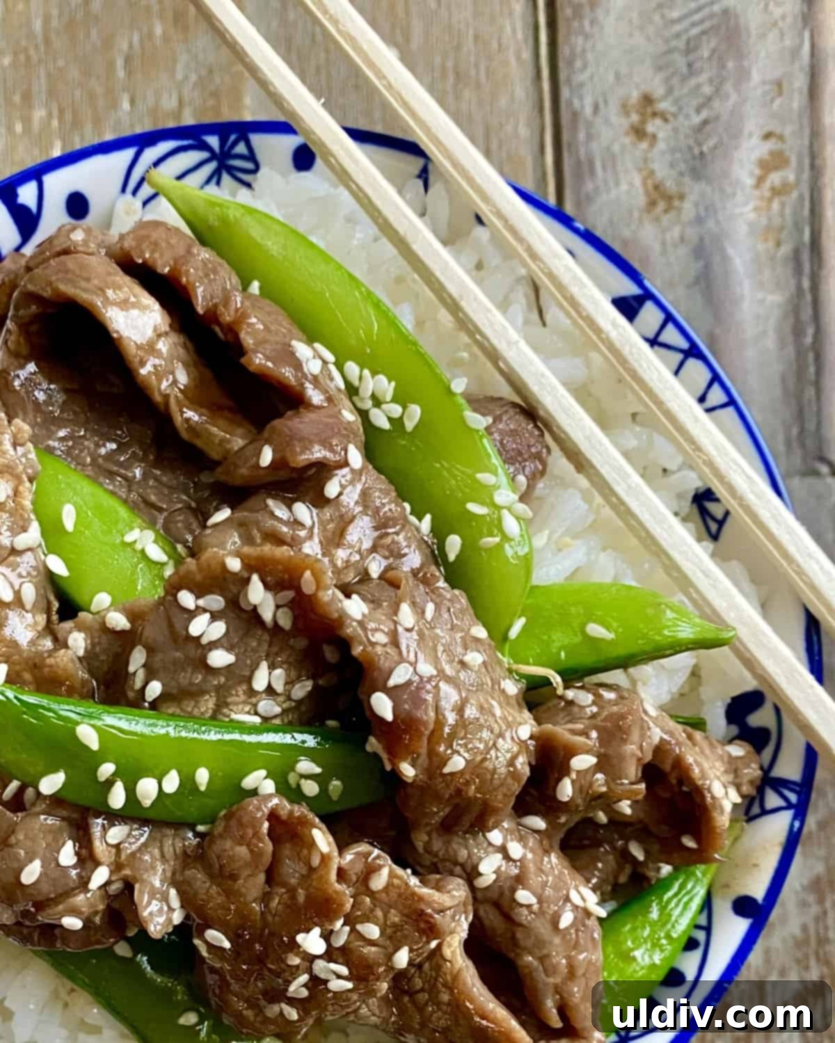 Tender Beef and Crisp Snap Pea Stir Fry 2 A vibrant beef stir fry with sugar snap peas and white rice in a bowl, ready to be enjoyed.