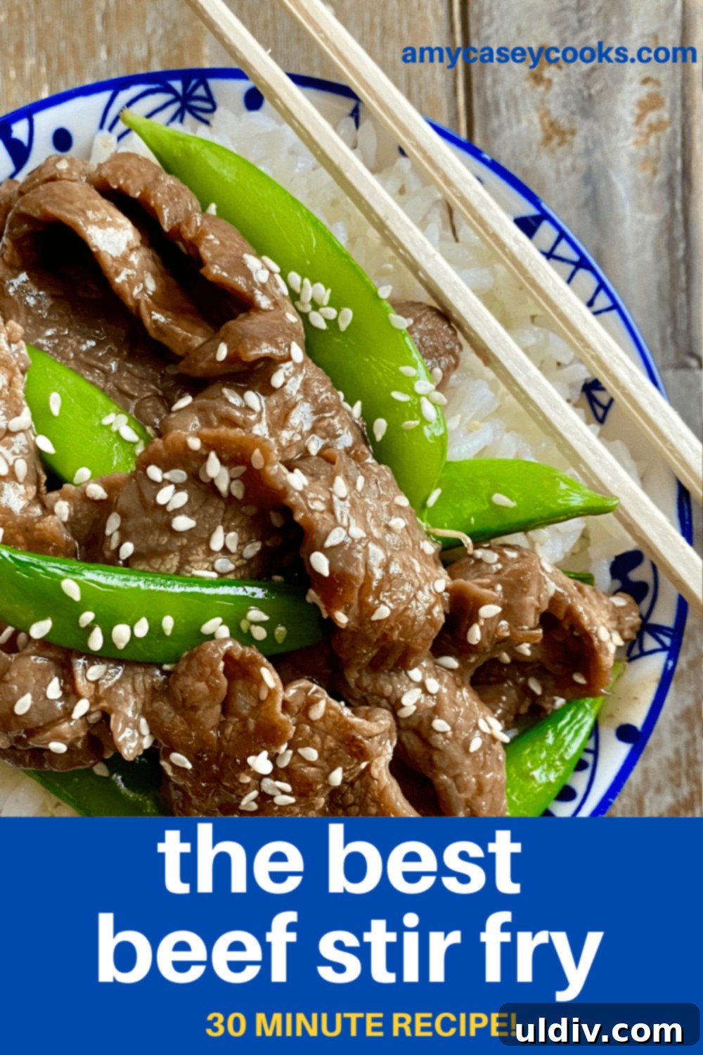 Tender Beef and Crisp Snap Pea Stir Fry 10 A bowl of beef stir fry with chopsticks, served over fluffy white rice, ready to be eaten.