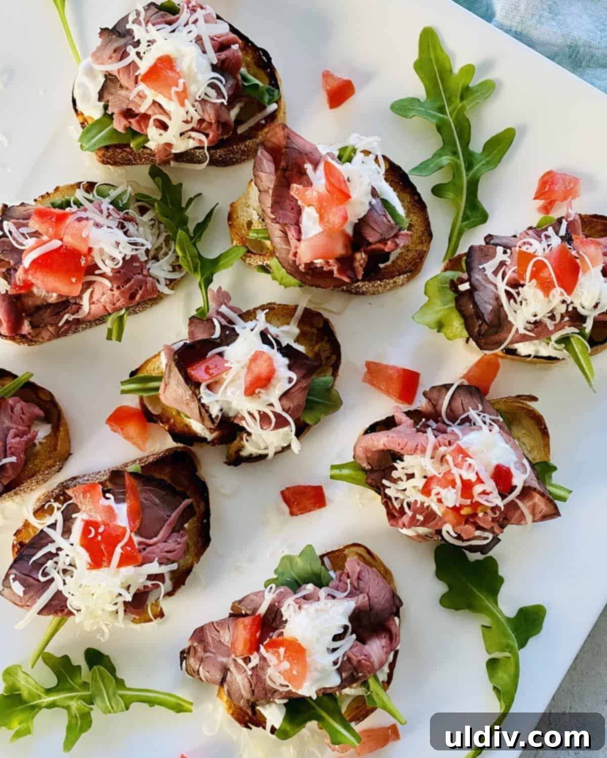Platter overflowing with perfectly arranged Roast Beef Crostini with Horseradish Cream