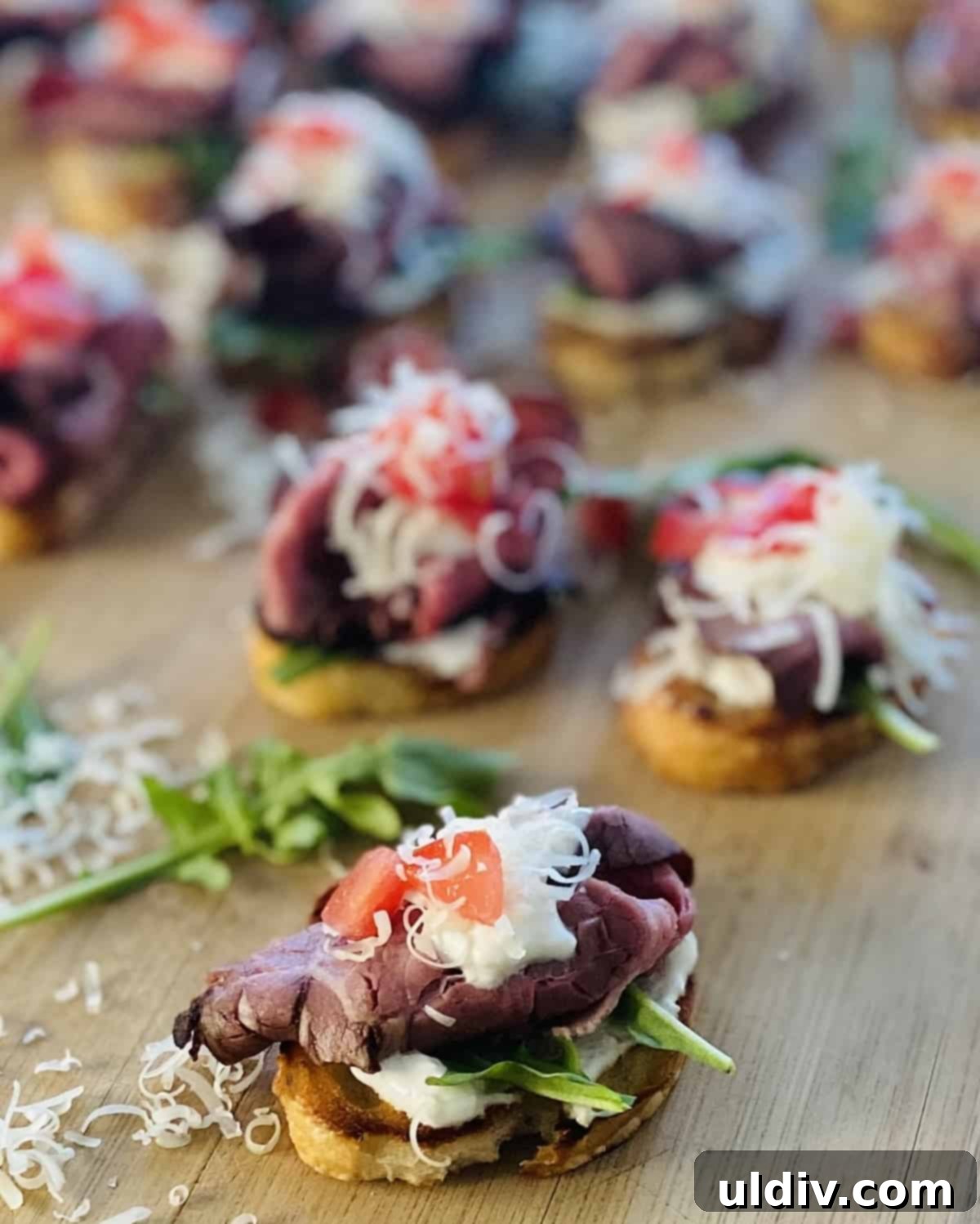 Zesty Roast Beef Crostini 9 cutting board toasted bread topped with sour cream horseradish and shredded cheese