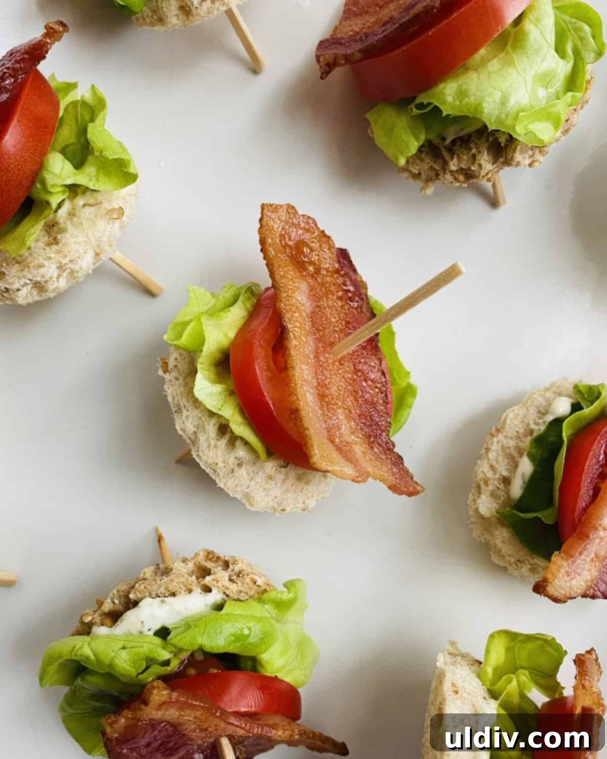 Mini BLT Sandwiches 2 A toothpick with bacon, lettuce and tomato snack.