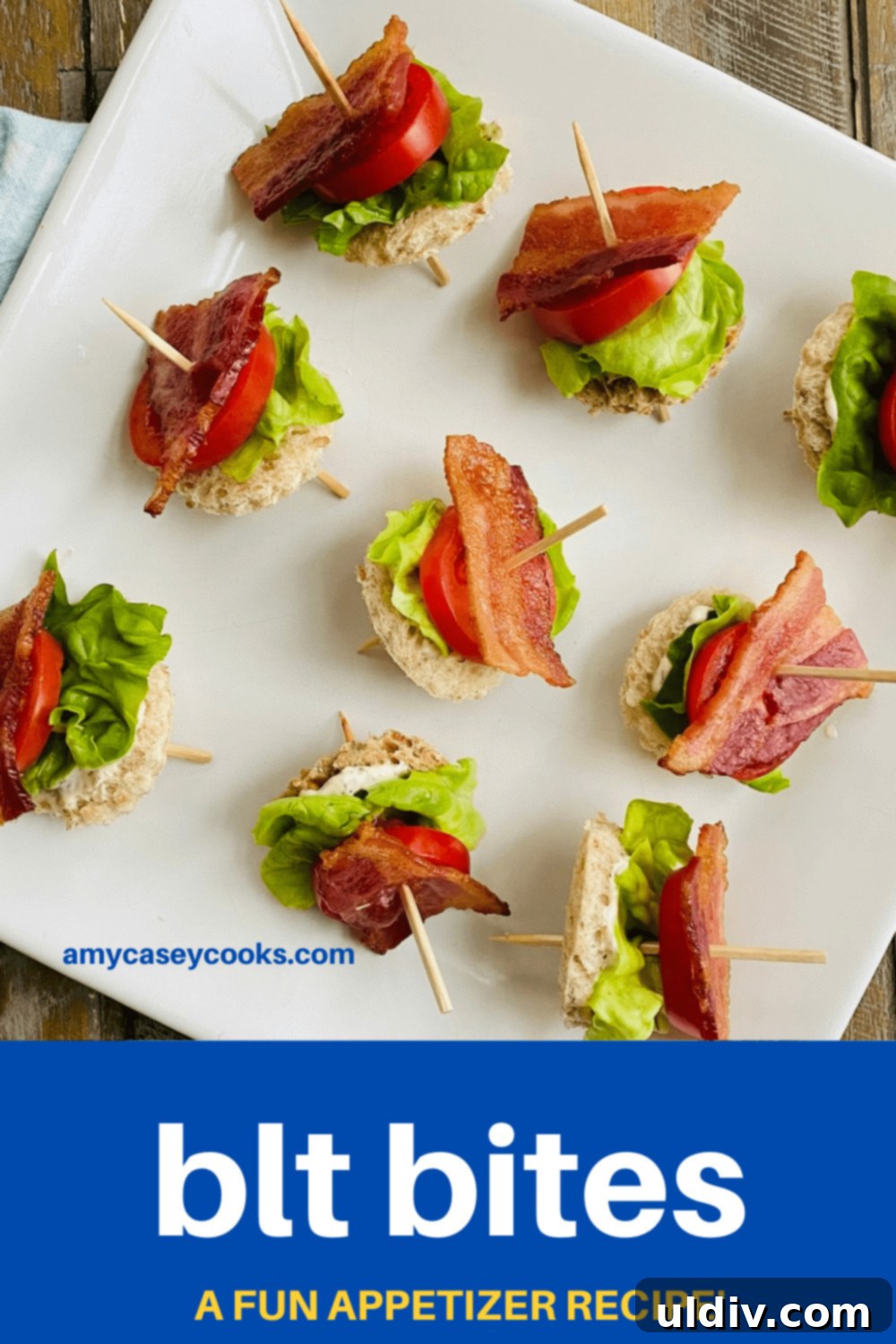 Mini BLT Sandwiches 11 Bacon appetizers on toothpicks on a white platter.