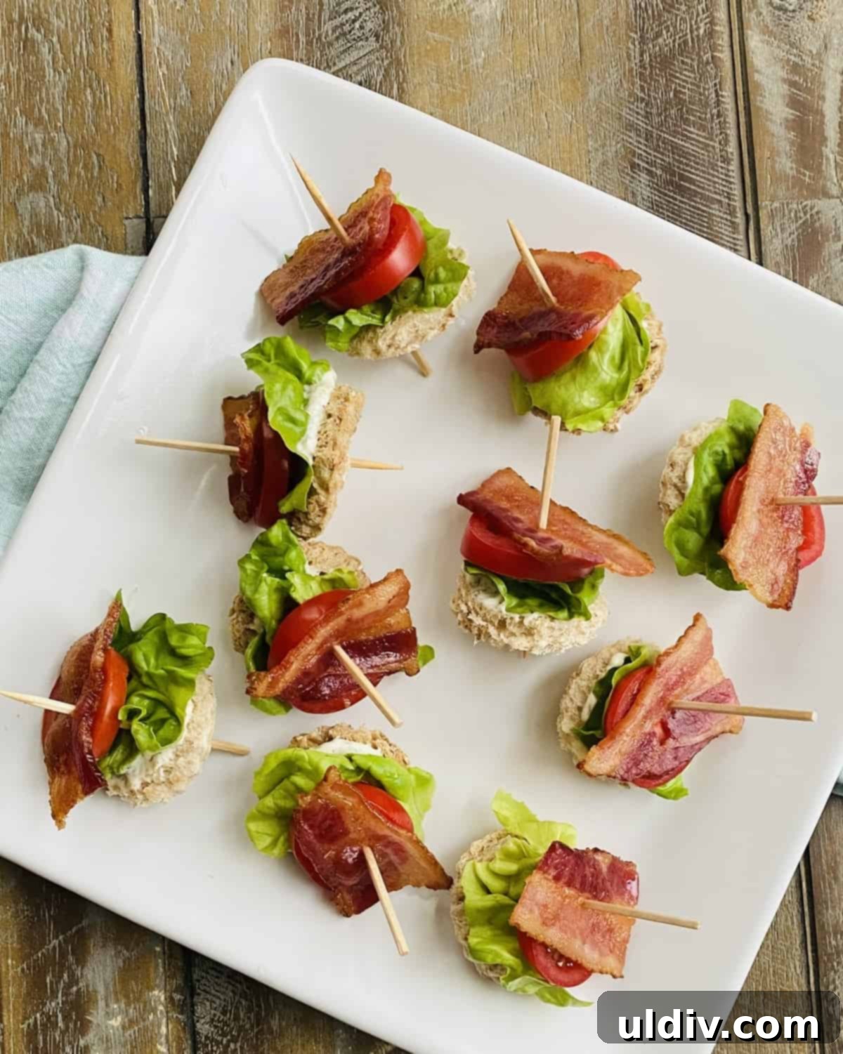 Bite-Sized BLT Sandwiches 10 A platter of blt appetizers on toothpicks.