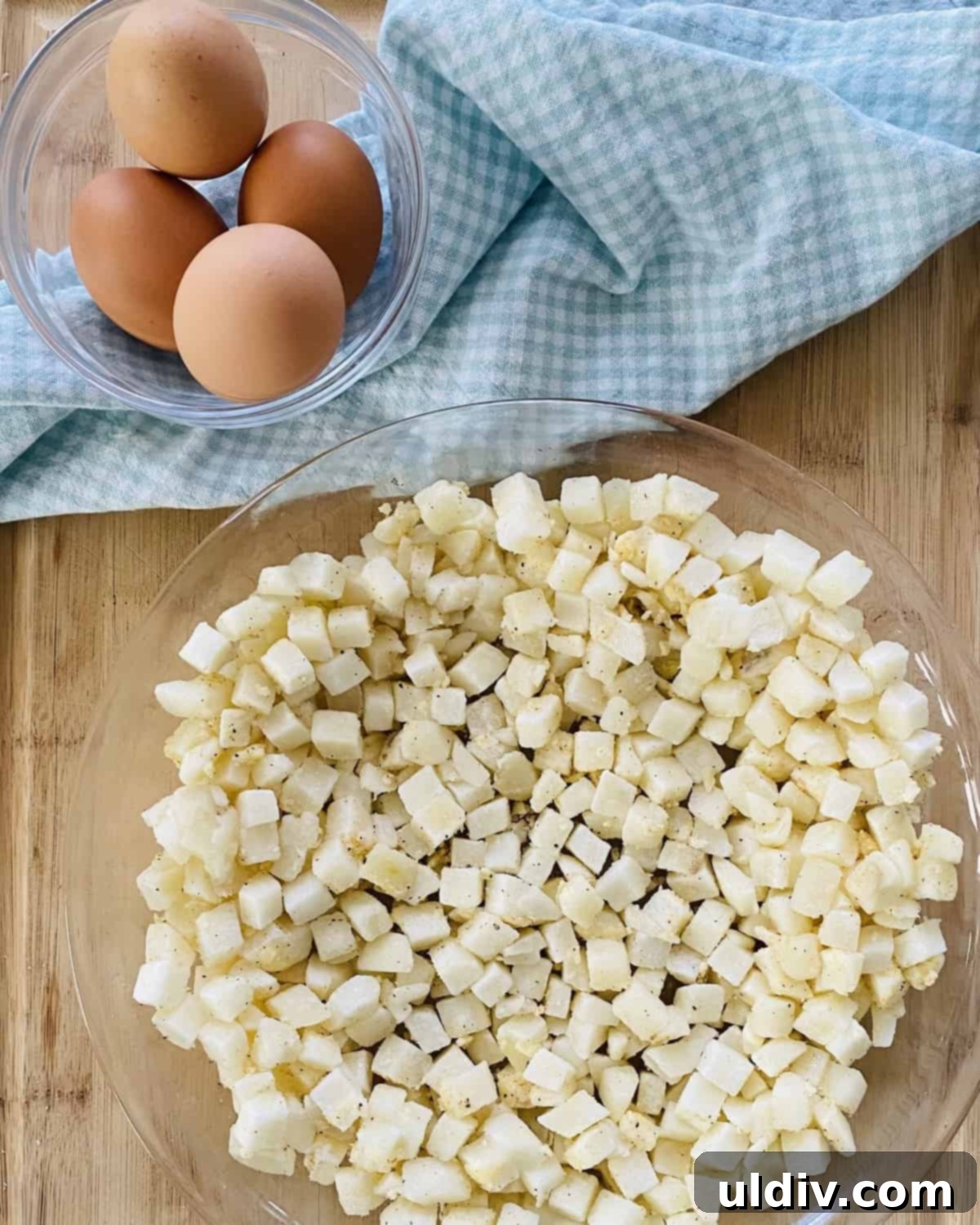 Golden Hash Brown Quiche: Ham and Cheese Delight 6 Hash browns pressed into a pie plate and a bowl of cracked eggs ready for whisking.