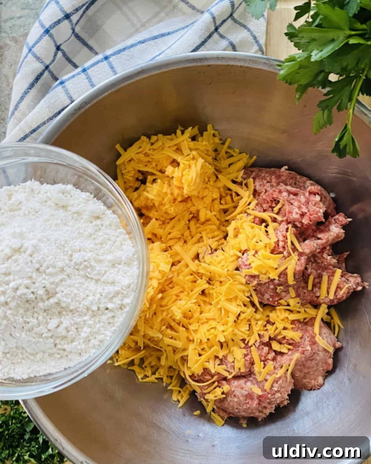 Grandma's Secret Bisquick Sausage Cheese Balls 4 Ground pork sausage, shredded cheese in a bowl with Bisquick.