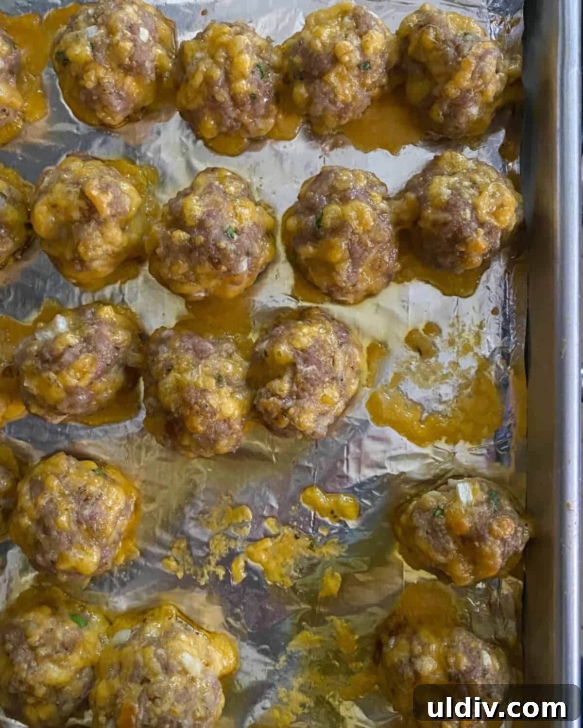 Grandma's Cheesy Bisquick Sausage Bites 9 Baked sausage balls on a baking sheet