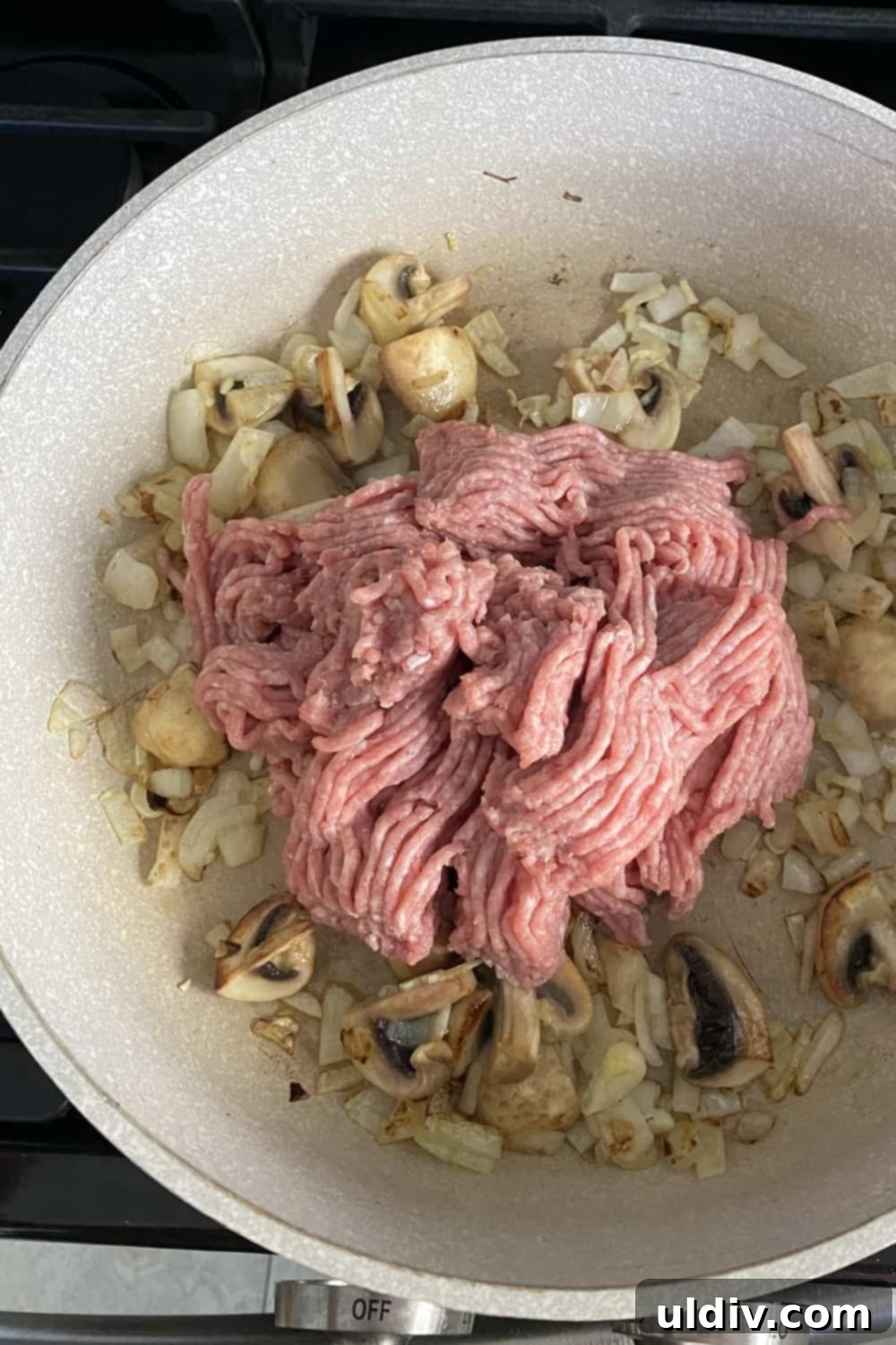 Creamy Cauliflower Shepherd's Pie 6 Sauteed mushrooms and onions with ground turkey in a pan.