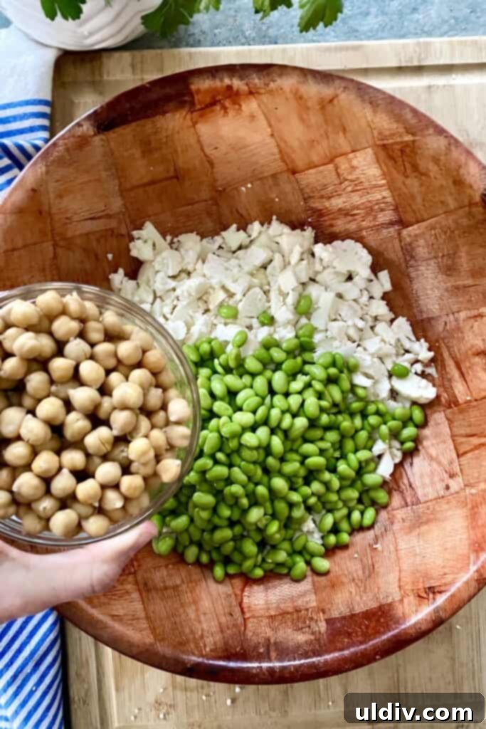 Vegetarian Cauliflower Salad with Edamame and Chickpeas 5 chopped cauliflower, edamame, chickpeas for salad in a bowl