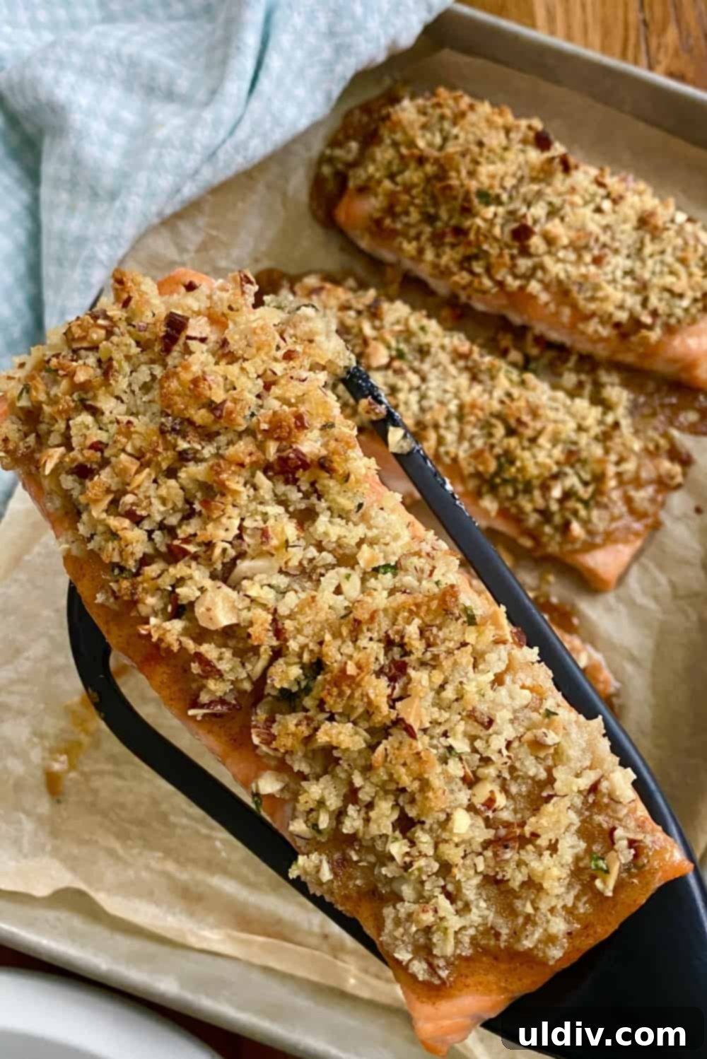 Golden Pecan Crusted Salmon with Honey Mustard 4 Baked pecan crusted salmon on a spatula.